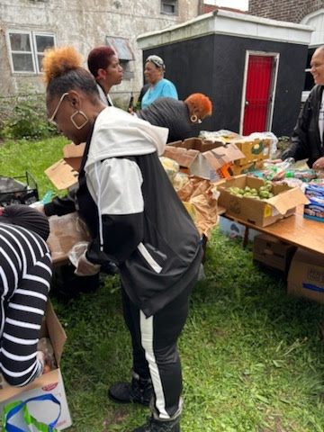 Members packing food pantry boxes for community outreach